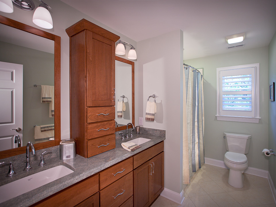 A bathroom with minty-neutral-colored interior walls.