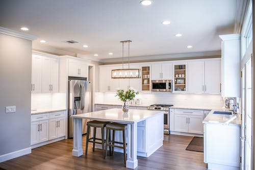 A stylish kitchen with white cabinets and counter