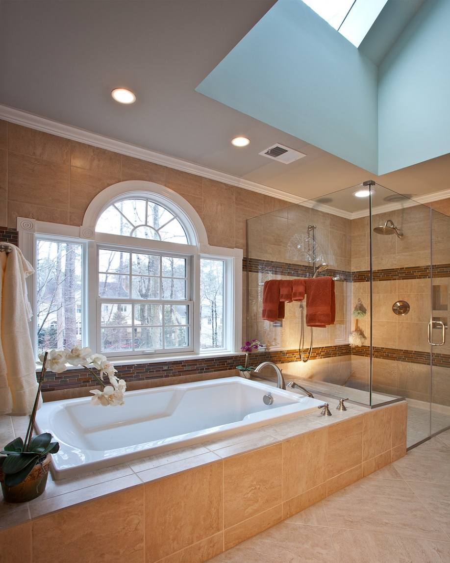 a well-lit bathroom with a huge tub