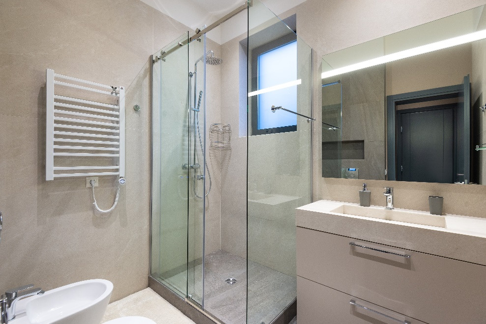A bathroom with separate shower space